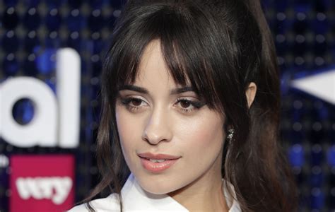 Camila Cabello serves bum cleavage in fluffy naked dress that。